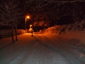 snow covered road at night snow covered road at night
